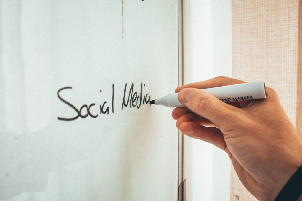 Image showing a hand writing why is social media marketing important for business